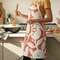 Hello Honey Cotton Printed Crossback Apron with Floral Pattern, Natural & Tomato Color
